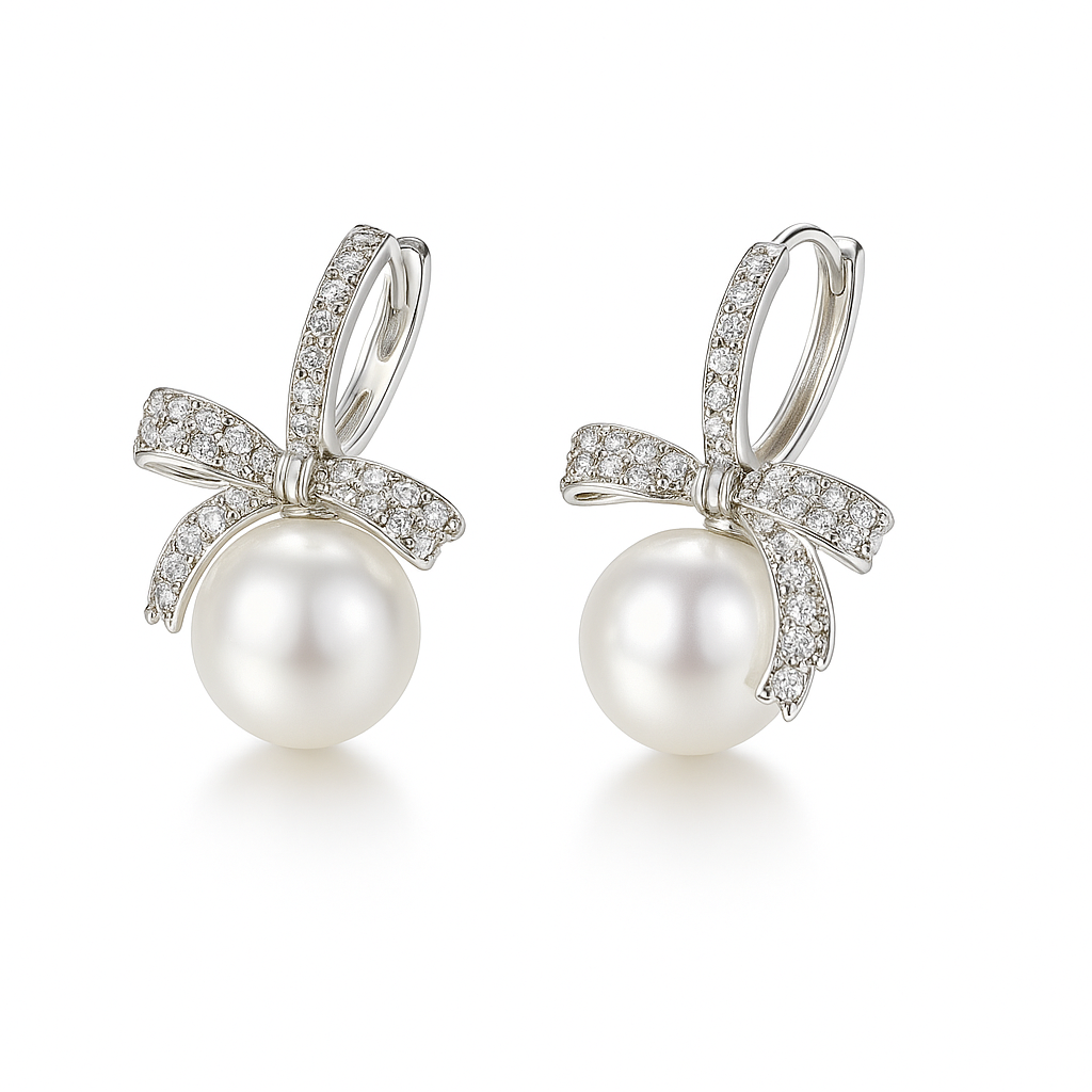 Elegant bow pearl drop earrings crafted in sterling silver with sparkling cubic zirconia details on a pure white background.