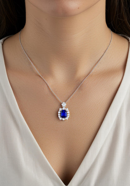 Elegant sapphire pendant surrounded by diamonds, silver chain close-up