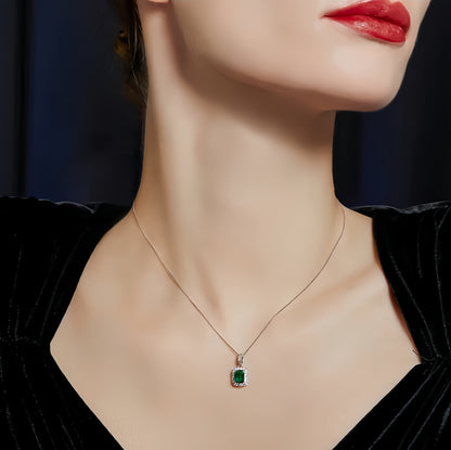 Aeterna Jewelry emerald pendant styled on model in black velvet dress