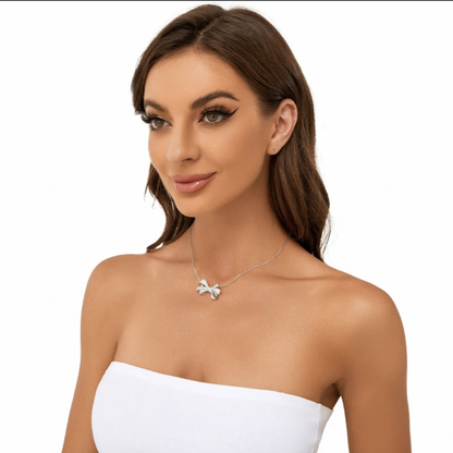 Side view of model wearing Aeterna Jewelry diamond bow necklace, sophisticated everyday jewelry for modern elegance