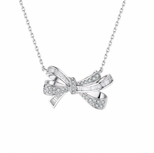 Elegant bow-shaped diamond pendant necklace in sterling silver by Aeterna Jewelry, refined modern minimalist design